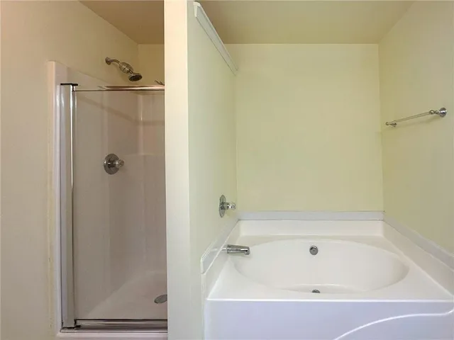 a bathroom with a tub and shower