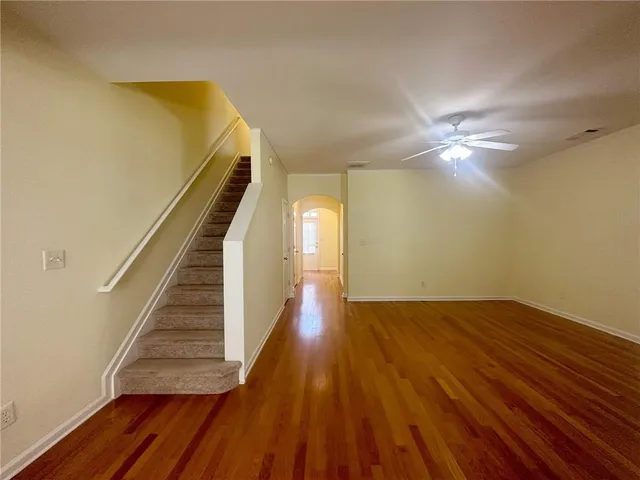 a view of a room with wooden floor and staircase