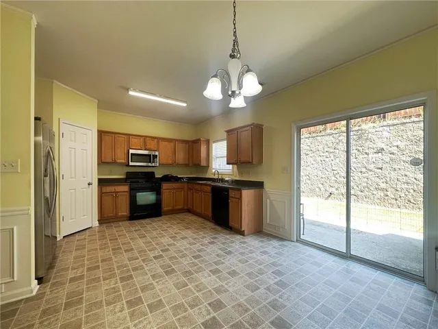 a large kitchen with a large counter top appliances and cabinets
