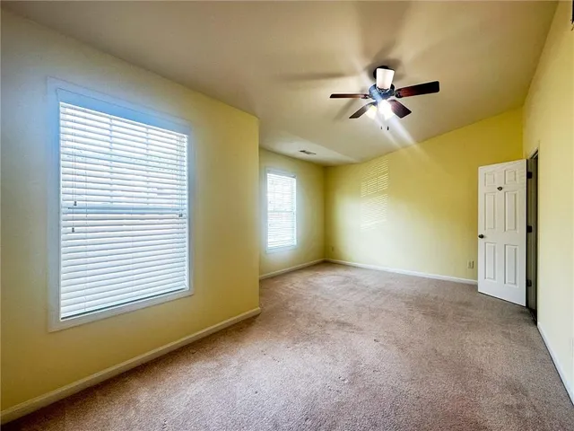 a view of a livingroom with a ceiling fan and window