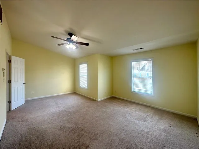 a view of a room with a ceiling fan and a window