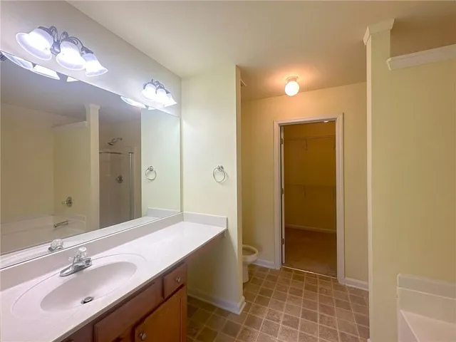 a bathroom with a double vanity sink a mirror and a shower