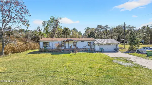 a swimming pool is sitting in front of a house with a yard