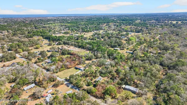 an aerial view of residential houses with city view