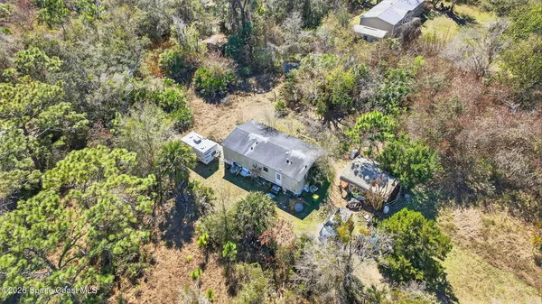 an aerial view of house with yard and outdoor seating