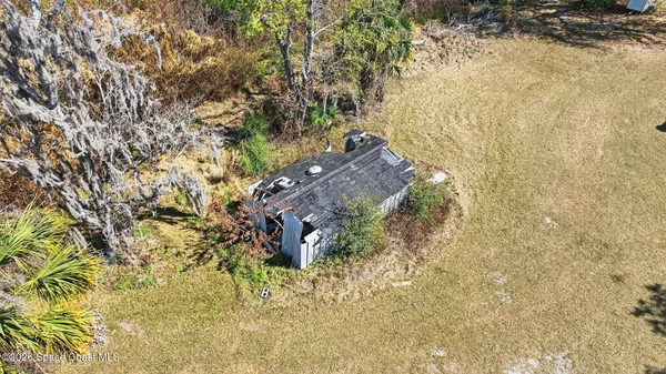 a aerial view of a house with a yard