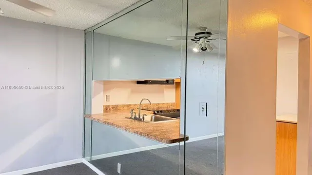 a kitchen with cabinets and stainless steel appliances