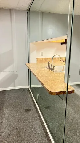 a kitchen with stainless steel appliances granite countertop a refrigerator sink and stove