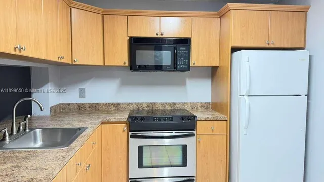 a kitchen with granite countertop a sink and a window