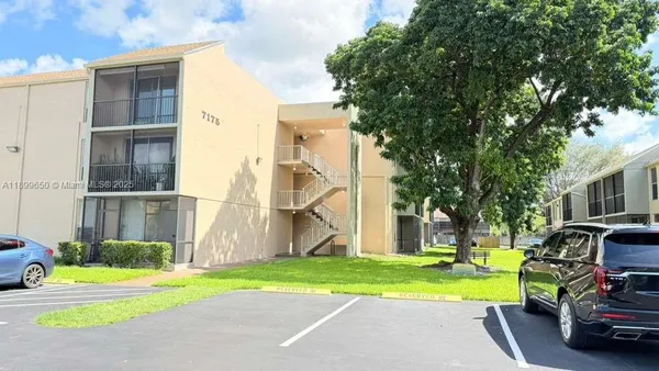 a view of a house with a patio and a yard
