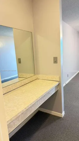 a bathroom with a shower and a mirror