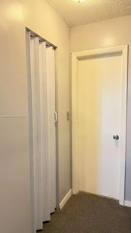 a view of a patio with a table and chairs