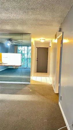 a tree in the grass next to a building