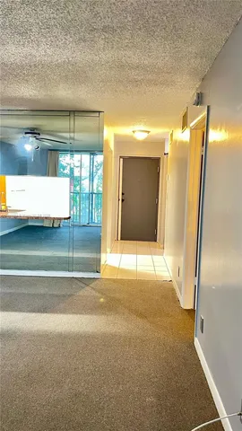 a tree in the grass next to a building