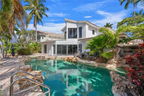 a view of a house with a yard and sitting area