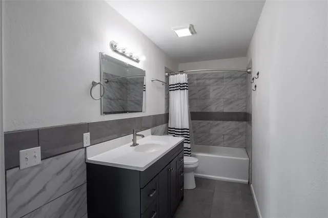 a bathroom with a sink mirror toilet and bathtub