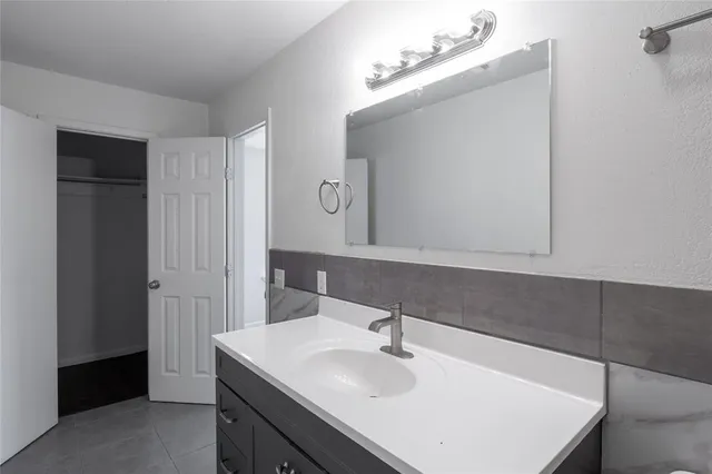 a bathroom with a sink vanity and a mirror