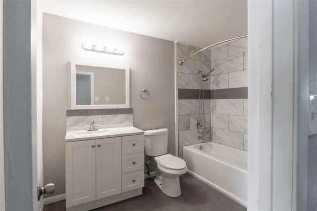 a bathroom with a toilet sink and shower