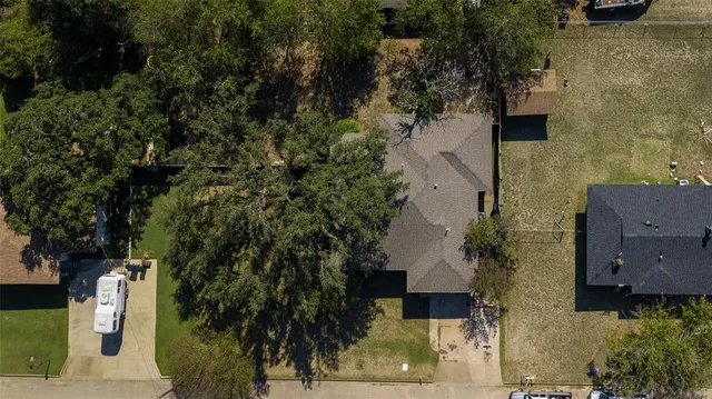 an aerial view of a house with a yard
