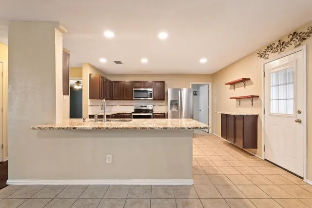 a large kitchen with stainless steel appliances and a cabinets