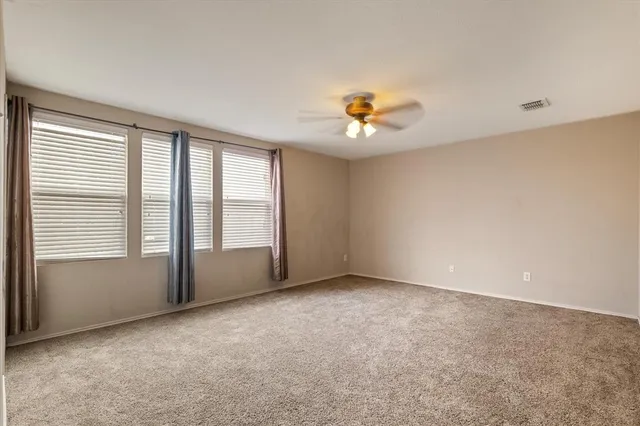 an empty room with windows and wooden floor