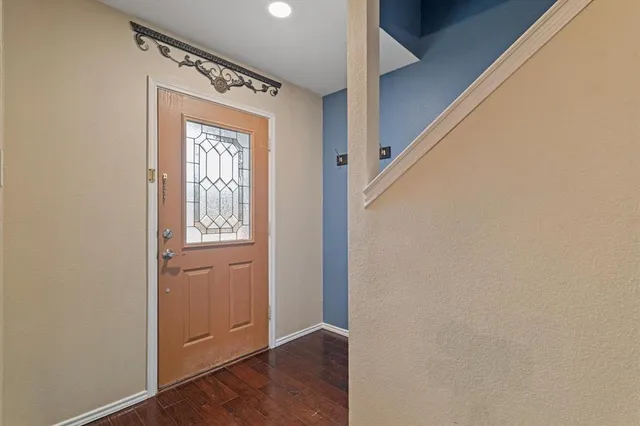 a view of front door with wooden floor