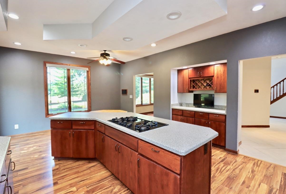 6210 Mc Donald Road Roscoe, IL 61073 - Photo 11 of 41 a kitchen with stainless steel appliances granite countertop a stove a sink dishwasher and a refrigerator with wooden floor