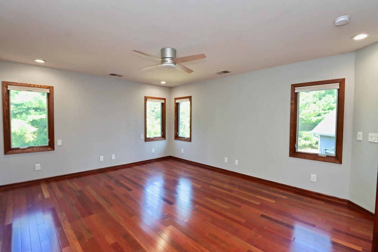 6210 Mc Donald Road Roscoe, IL 61073 - Photo 17 of 41 a view of an empty room with wooden floor and a window