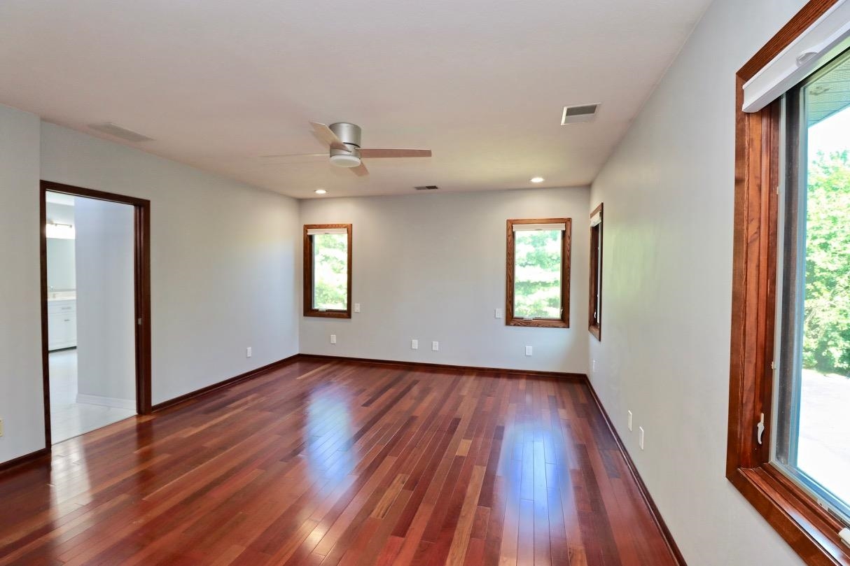6210 Mc Donald Road Roscoe, IL 61073 - Photo 18 of 41 an empty room with wooden floor and windows