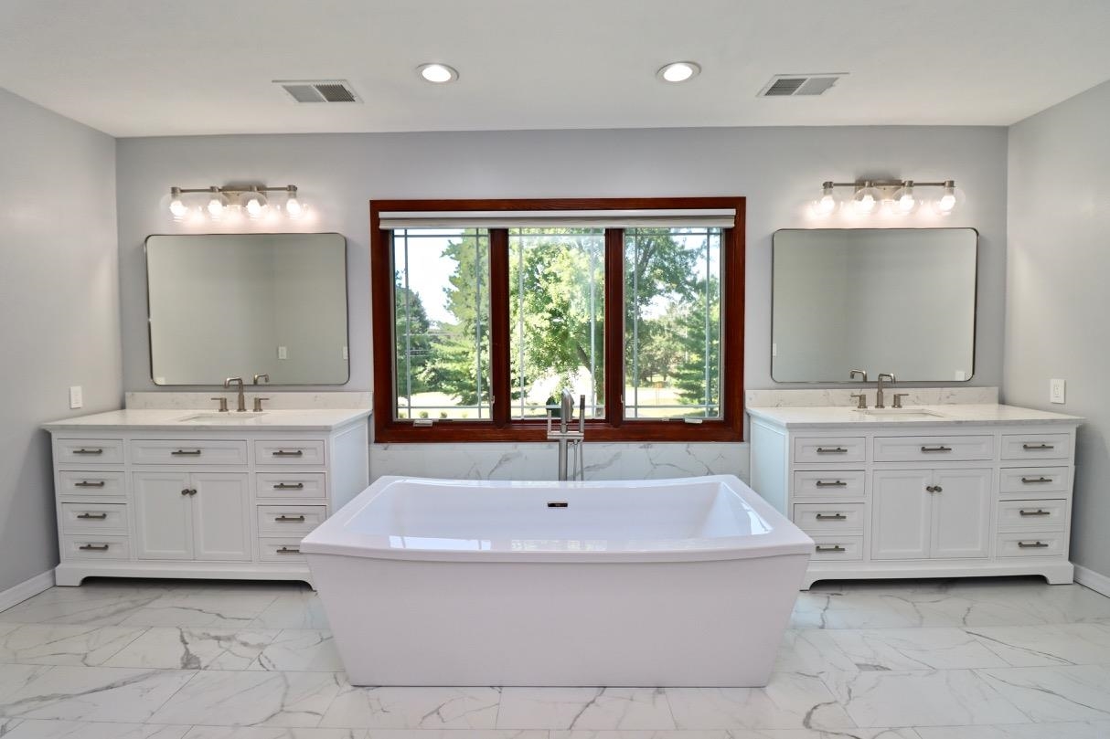 6210 Mc Donald Road Roscoe, IL 61073 - Photo 19 of 41 a bathroom with a sink a large mirror and a window
