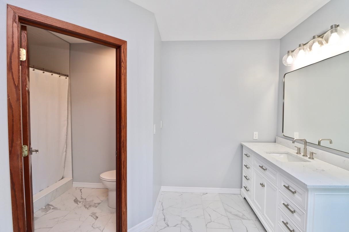 6210 Mc Donald Road Roscoe, IL 61073 - Photo 20 of 41 a bathroom with a sink a toilet and shower