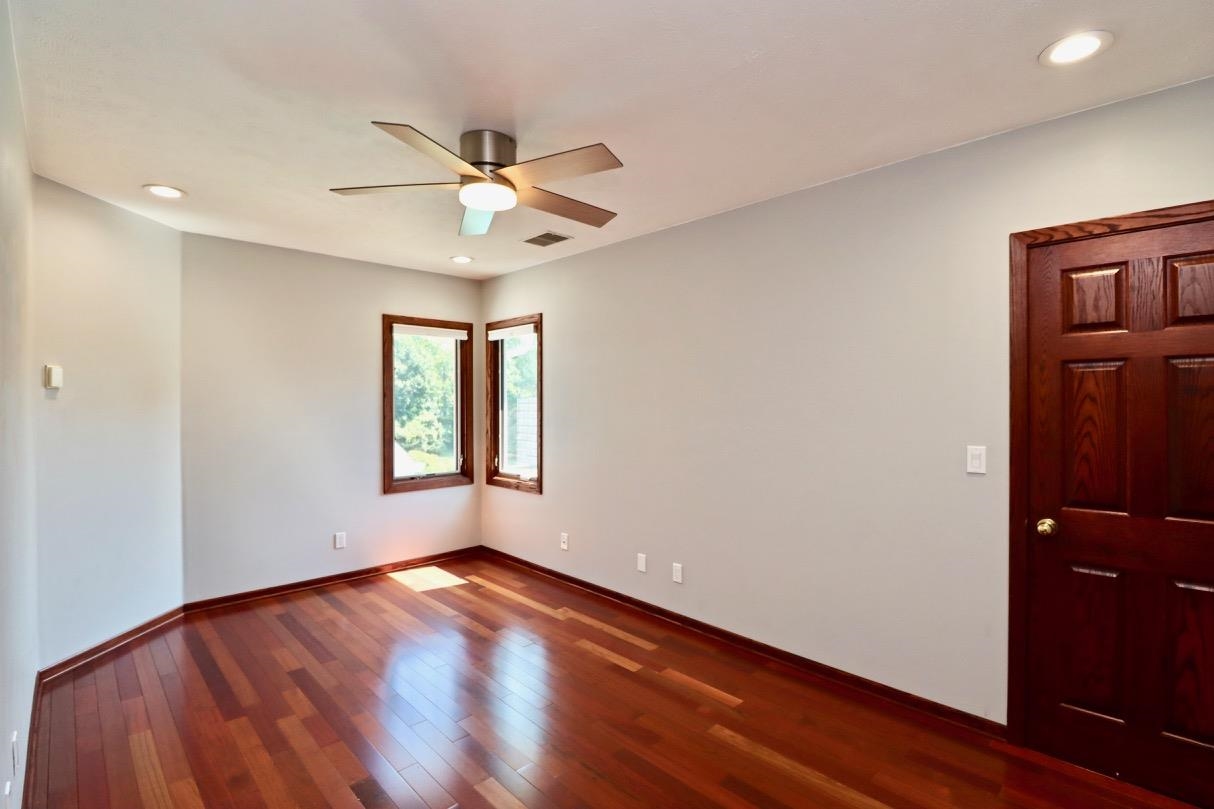 6210 Mc Donald Road Roscoe, IL 61073 - Photo 29 of 41 a view of empty room with wooden floor and fan