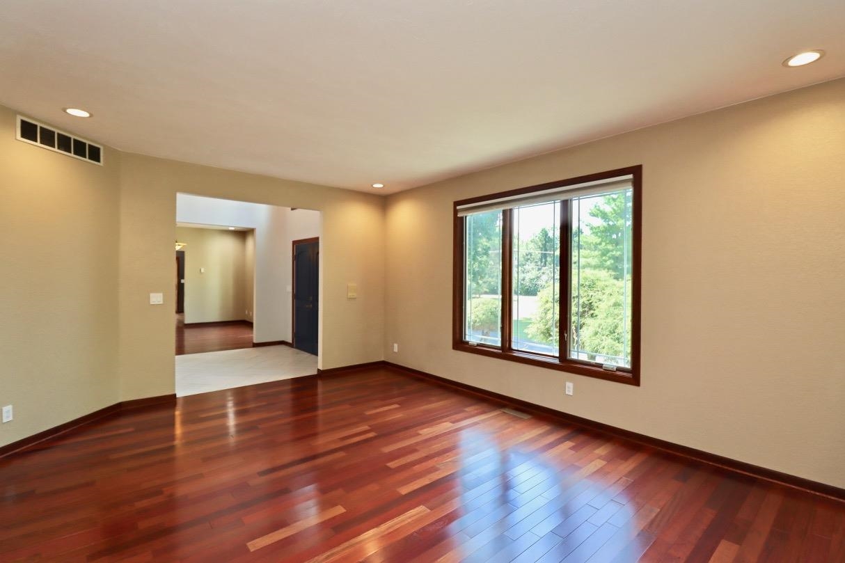 6210 Mc Donald Road Roscoe, IL 61073 - Photo 8 of 41 a view of an empty room with wooden floor and a window