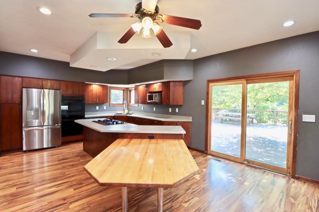 6210 Mc Donald Road Roscoe, IL 61073 - Photo 9 of 41 a kitchen with stainless steel appliances granite countertop a stove and a refrigerator