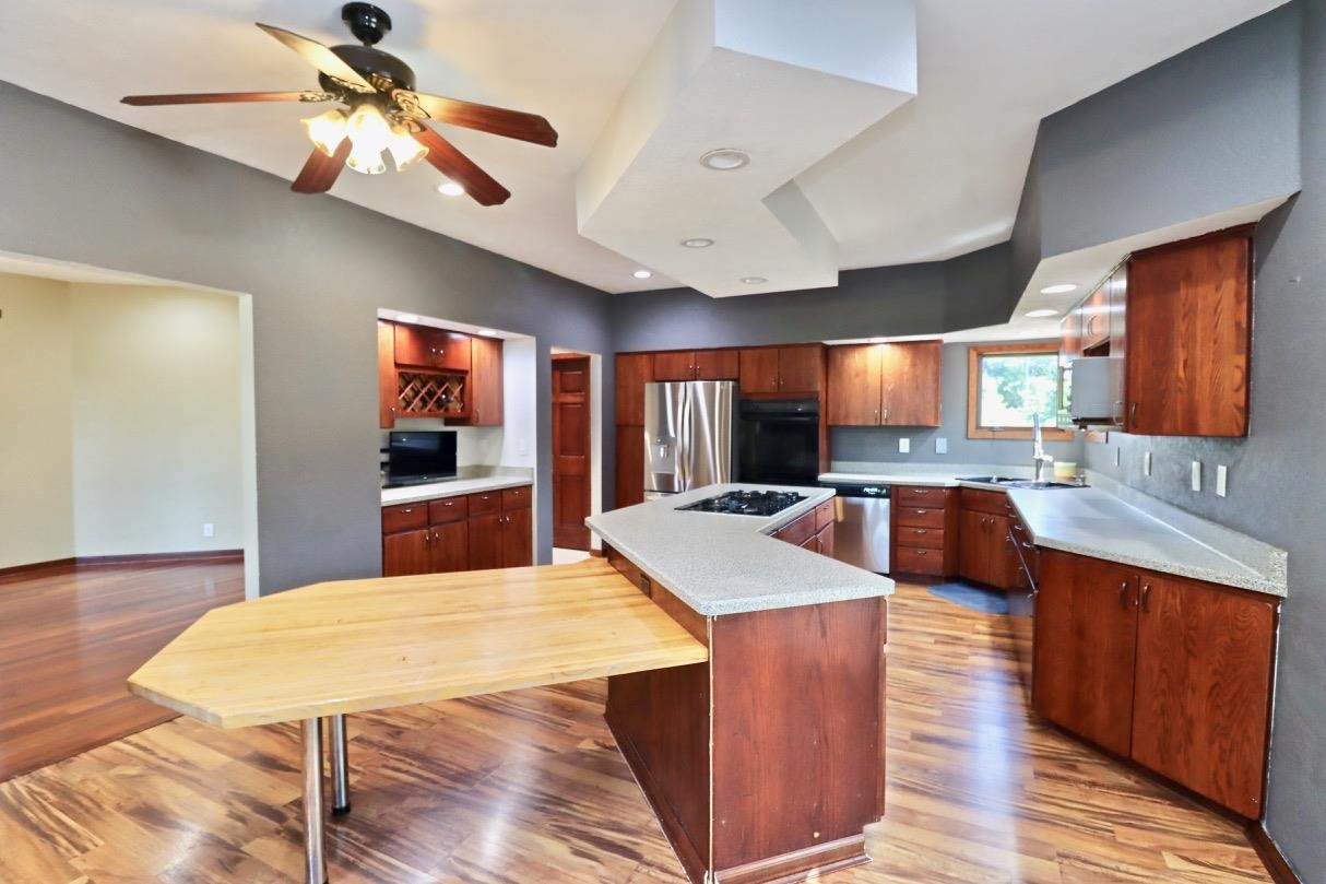 6210 Mc Donald Road Roscoe, IL 61073 - Photo 10 of 41 a large kitchen with stainless steel appliances kitchen island granite countertop a large island in the center