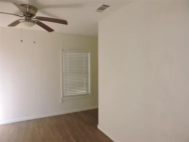 a view of a livingroom with a ceiling fan and window