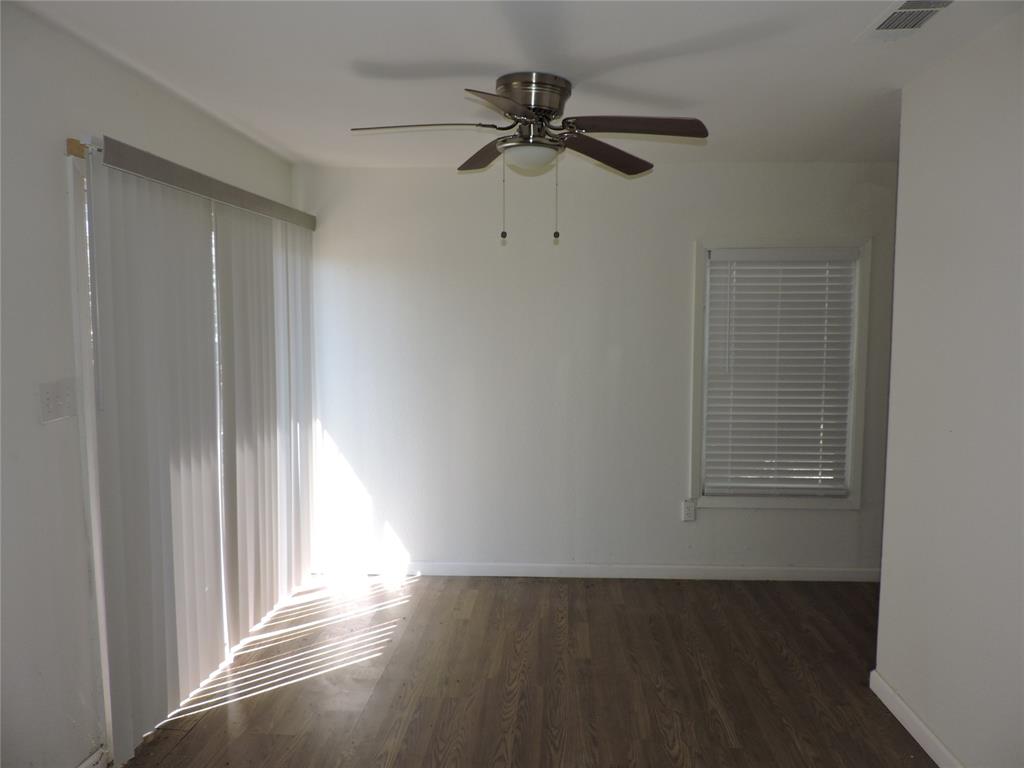 1612 North Anglin Street Cleburne, TX 76031 - Photo 13 of 16 a view of a livingroom with a ceiling fan and window