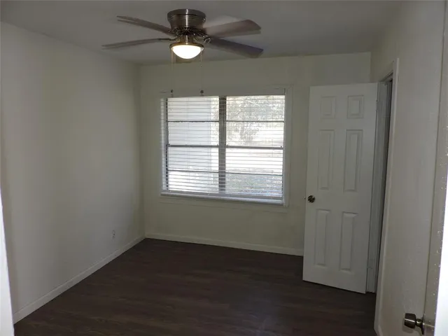 a bathroom with a granite countertop toilet and a shower