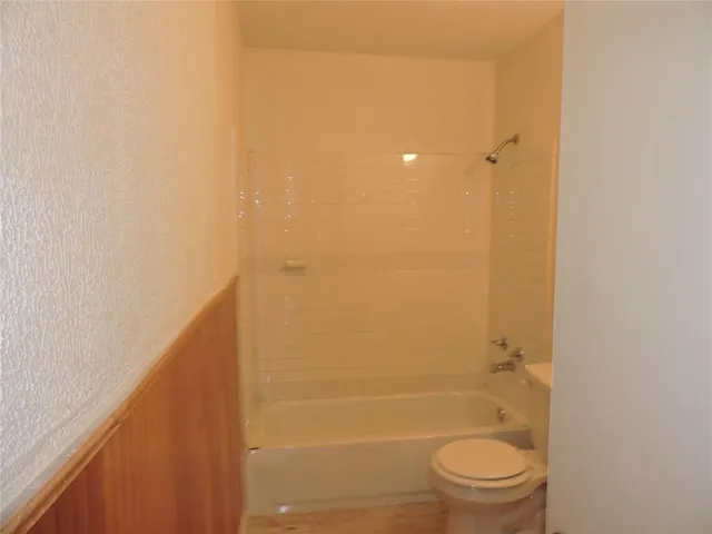 a bathroom with a shower and a toilet