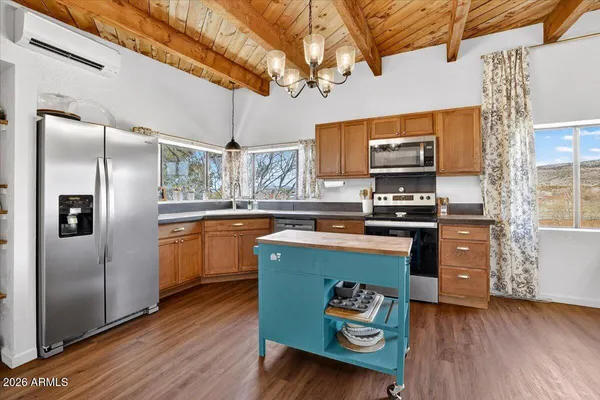 a dining room with furniture a chandelier and wooden floor