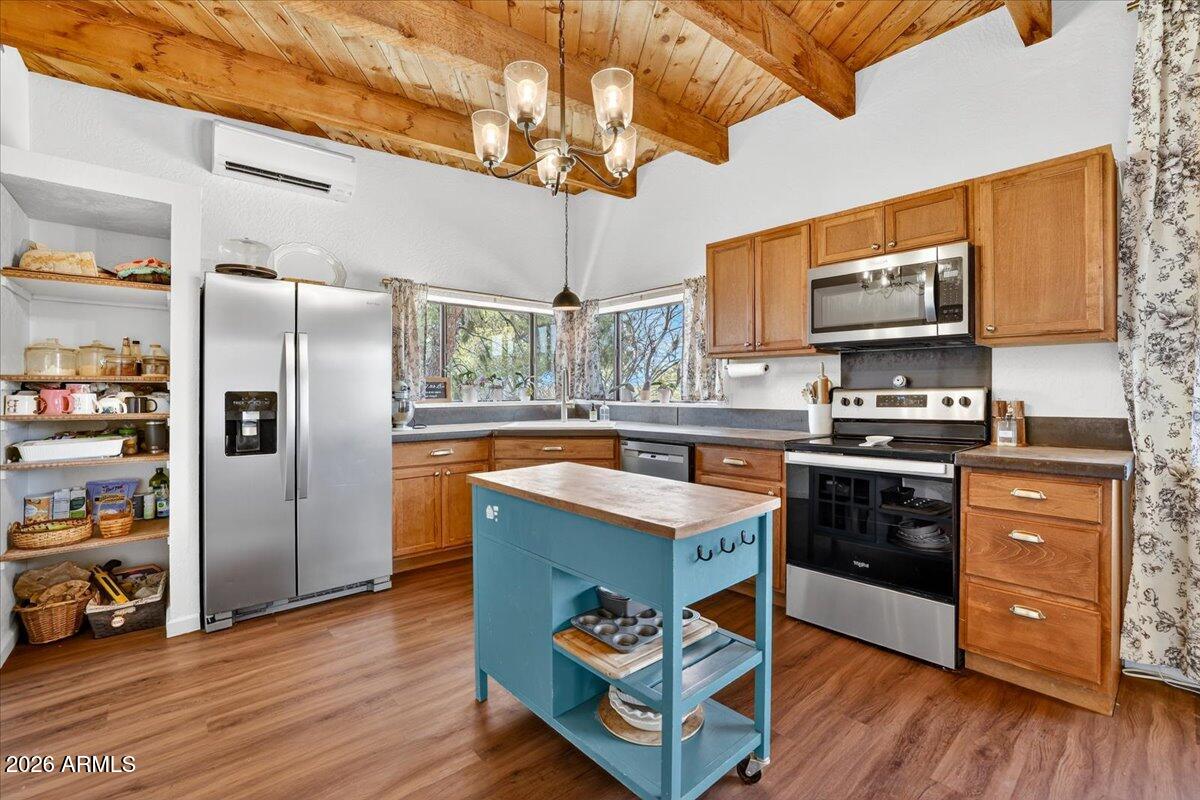 13505 East Rindone Lane Cornville, AZ 86325 - Photo 16 of 73 a kitchen with stainless steel appliances granite countertop a refrigerator a stove a sink and dishwasher with wooden floor