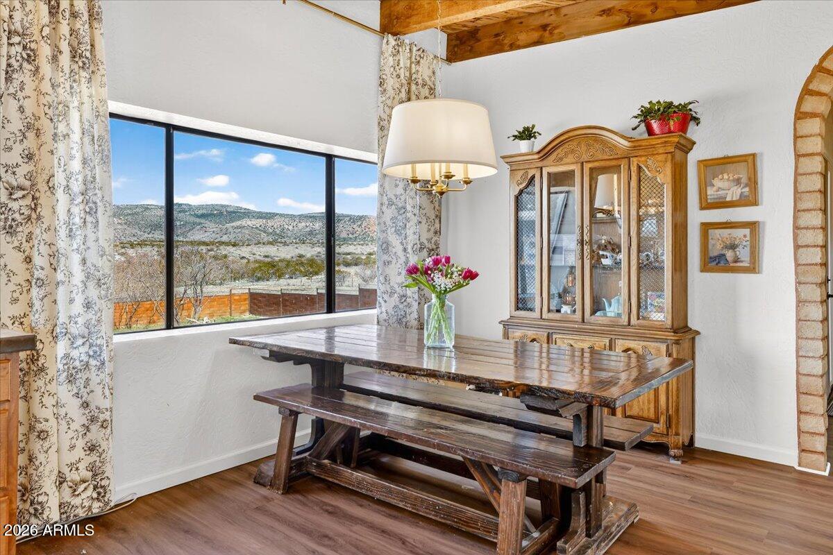 13505 East Rindone Lane Cornville, AZ 86325 - Photo 19 of 73 a dining room with furniture a chandelier and wooden floor