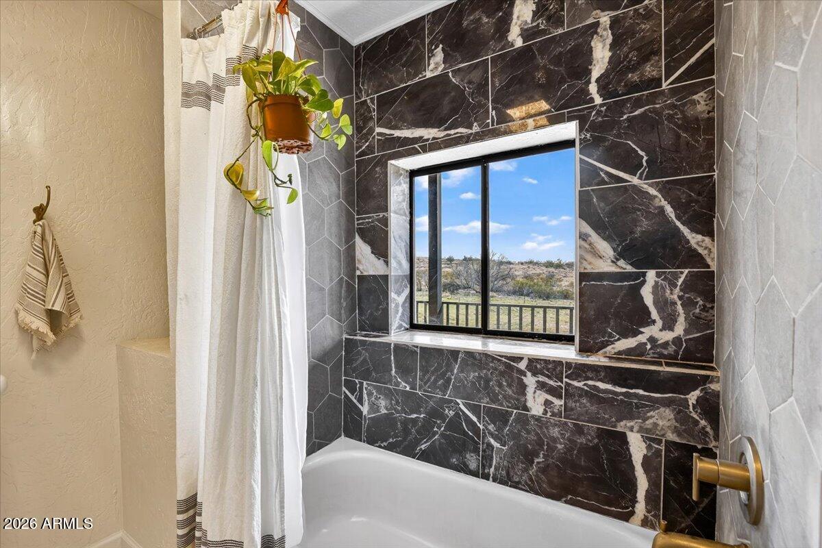 13505 East Rindone Lane Cornville, AZ 86325 - Photo 31 of 73 a bathroom with a sink window and shower