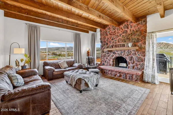 a view of a livingroom with furniture wooden floor and windows