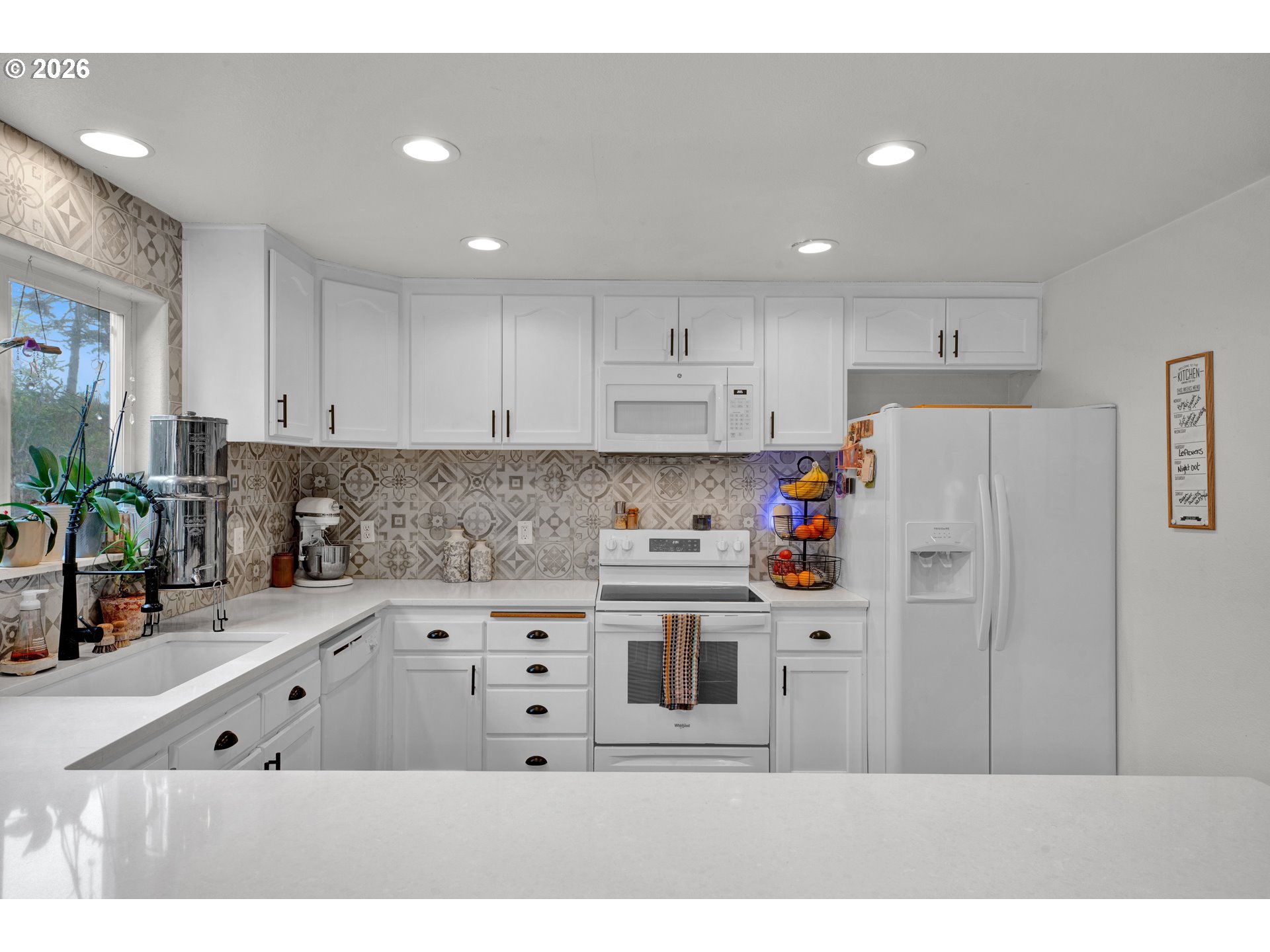 1265 Laurel Street Florence, OR 97439 - Photo 16 of 42 a kitchen with stainless steel appliances kitchen island sink refrigerator and cabinets