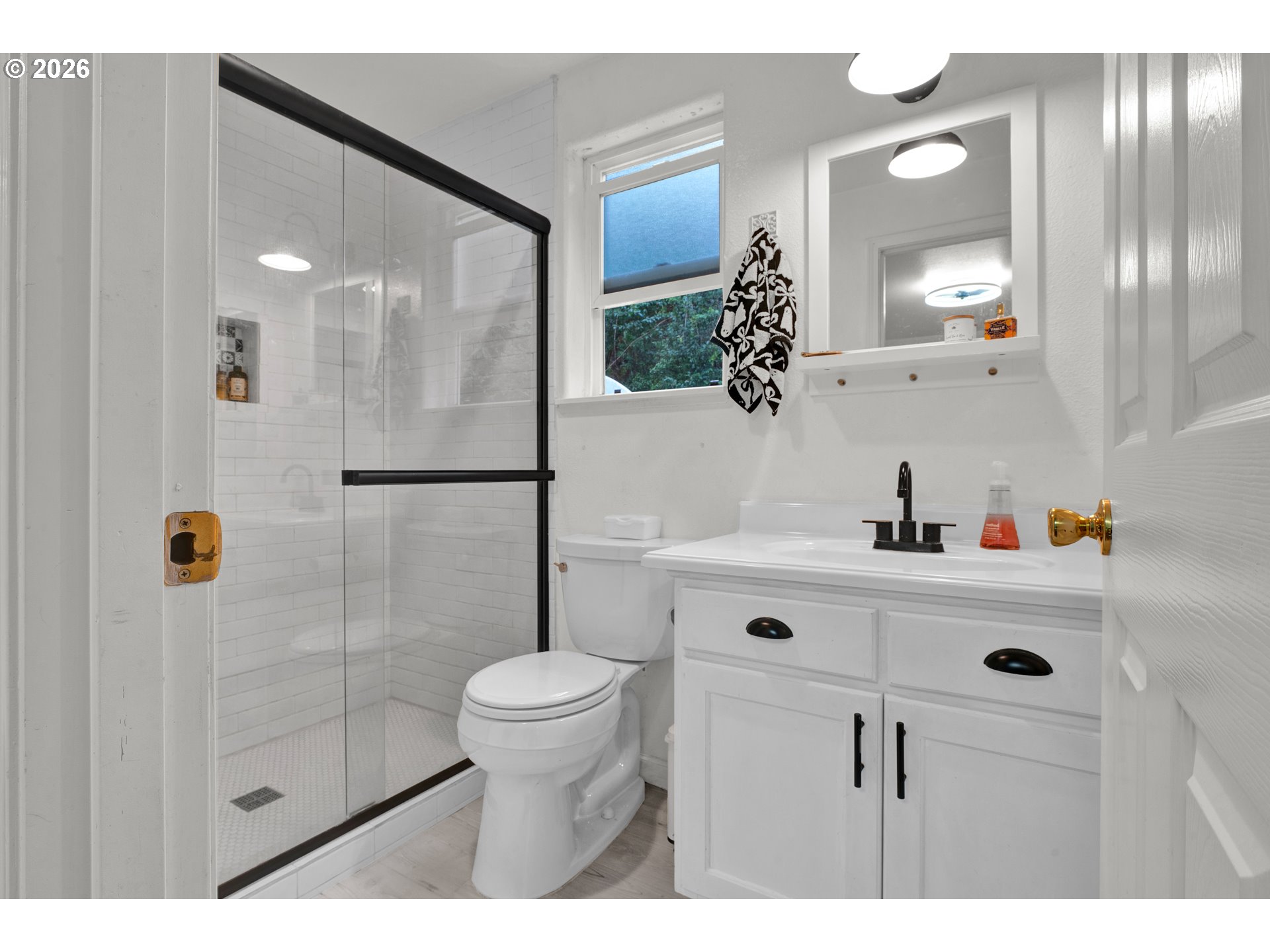1265 Laurel Street Florence, OR 97439 - Photo 25 of 42 a bathroom with a sink a toilet a mirror and shower