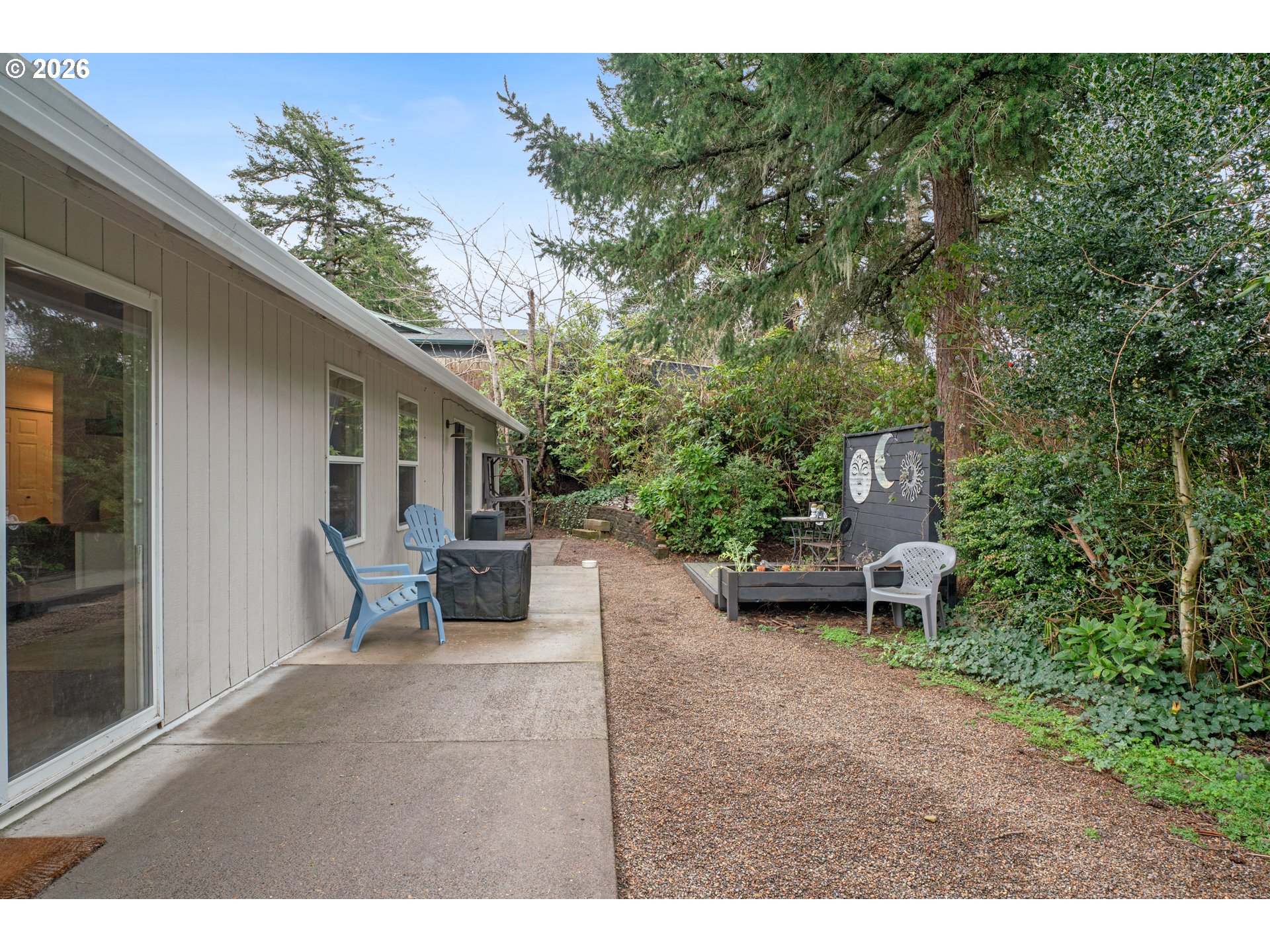 1265 Laurel Street Florence, OR 97439 - Photo 34 of 42 a backyard of a house with table and chairs