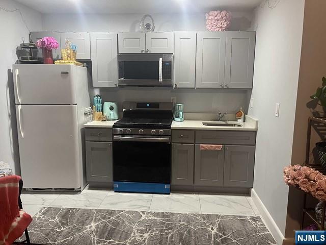 259 MacArthur Avenue, Unit 2 Garfield, NJ 07026 - Photo 1 of 12 a kitchen with a refrigerator stove and microwave