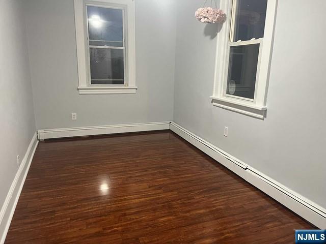 259 MacArthur Avenue, Unit 2 Garfield, NJ 07026 - Photo 7 of 12 a view of an empty room with wooden floor and a window