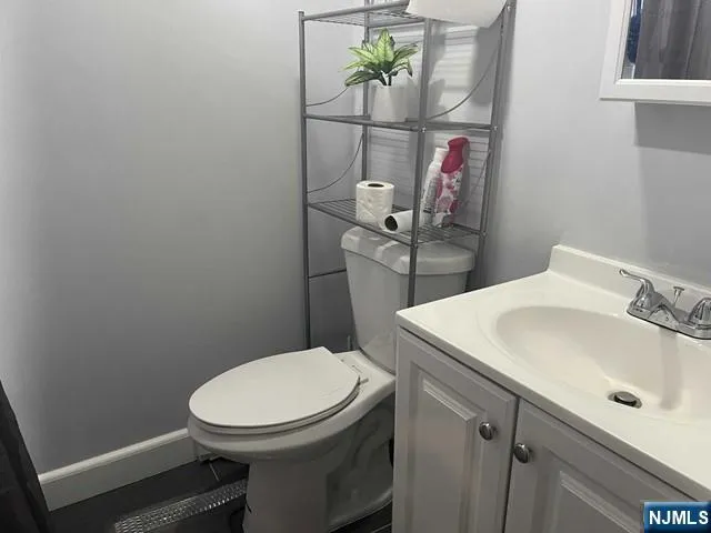 a bathroom with a sink a toilet and vanity
